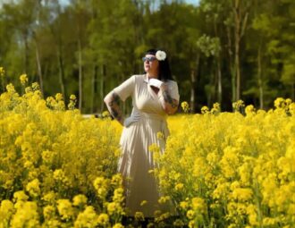 une fleur dans les cheveux parmis les fleurs de colza